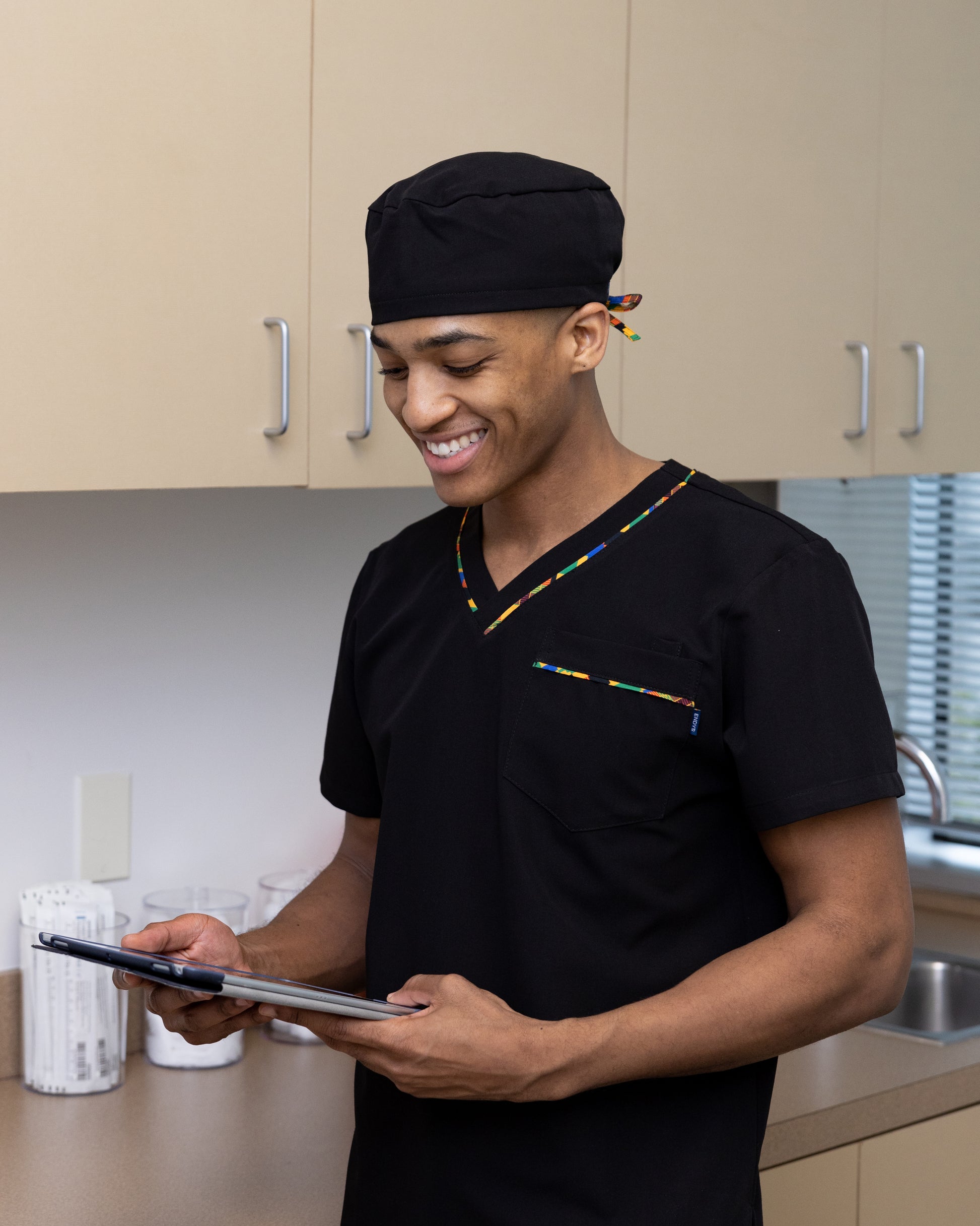 ENDYS black unisex scrub cap with Heritage Pop ties — satin-lined, adjustable tie-back, classic black with bold geometric print ties
