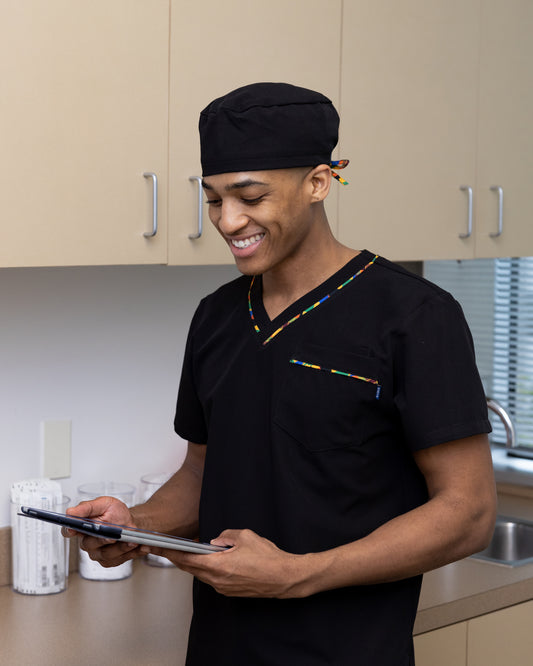 ENDYS black unisex scrub cap with Heritage Pop ties — satin-lined, adjustable tie-back, classic black with bold geometric print ties