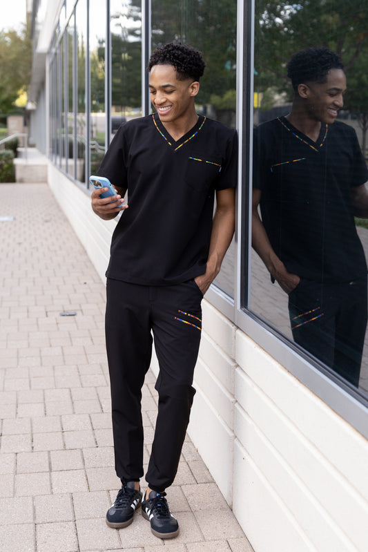 ENDYS Heritage Pop men's black scrub top front view — signature Heritage Pop print on pockets, athletic fit