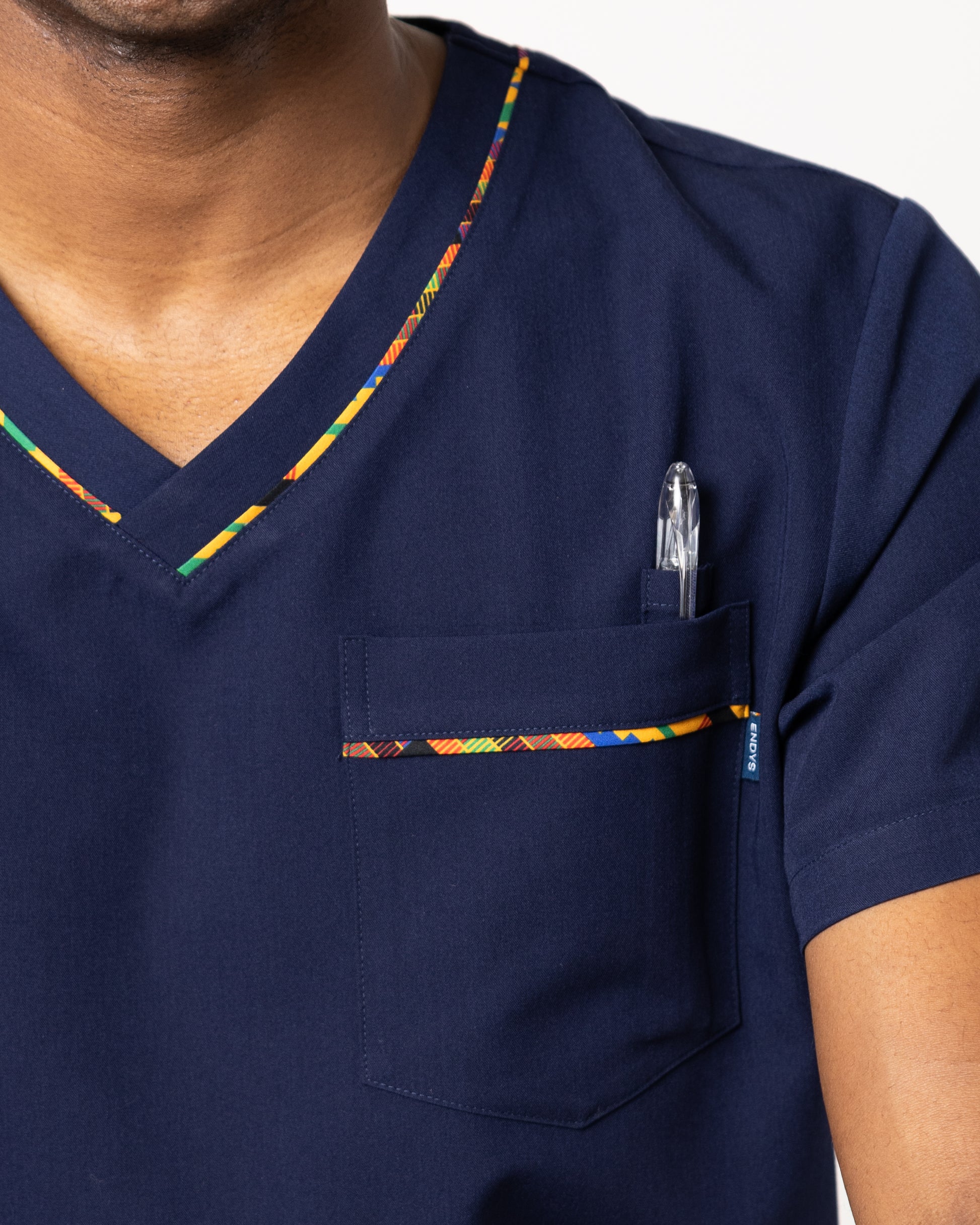 Image 4: ENDYS Heritage Pop men's navy medical scrub top — relaxed athletic fit with bold geometric print detail