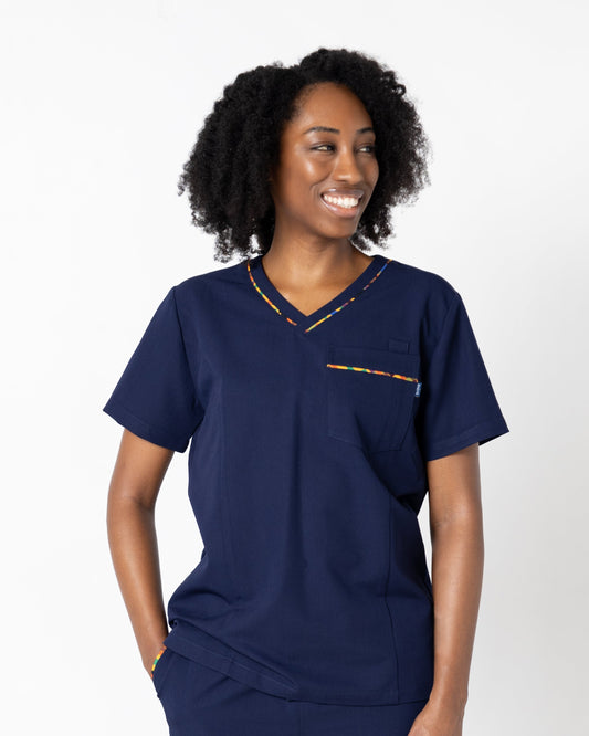 ENDYS Heritage Pop women's navy scrub top front view — signature geometric print detail on pockets and neckline