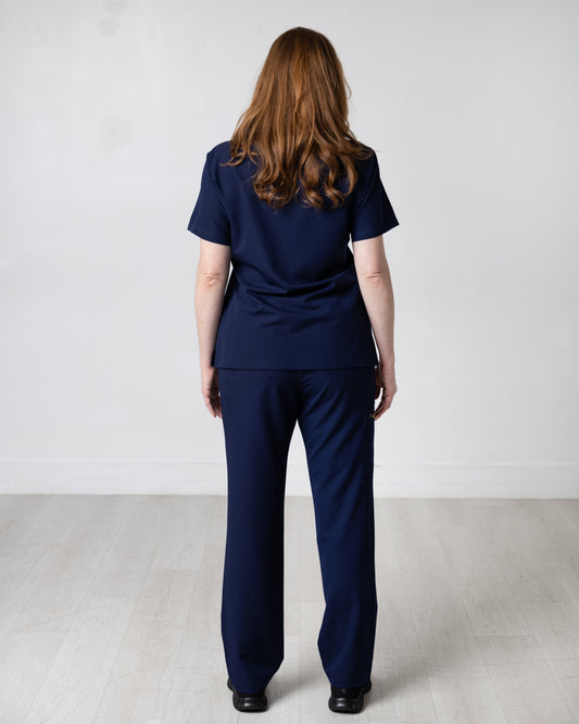 ENDYS Heritage Pop women's navy scrub pants front view — signature geometric print trim detail