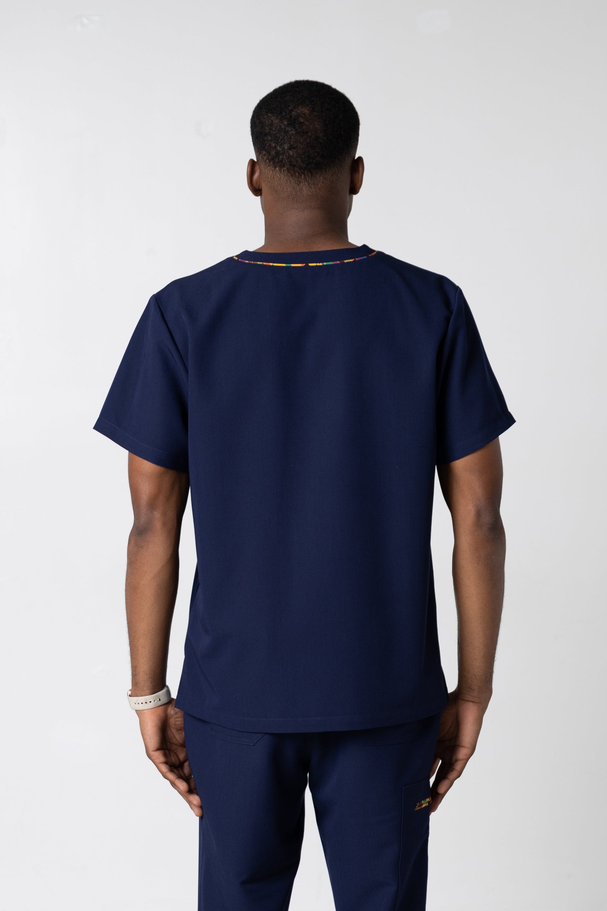 ENDYS Heritage Pop men's navy scrub top front view — signature Heritage Pop print on chest and lower pockets