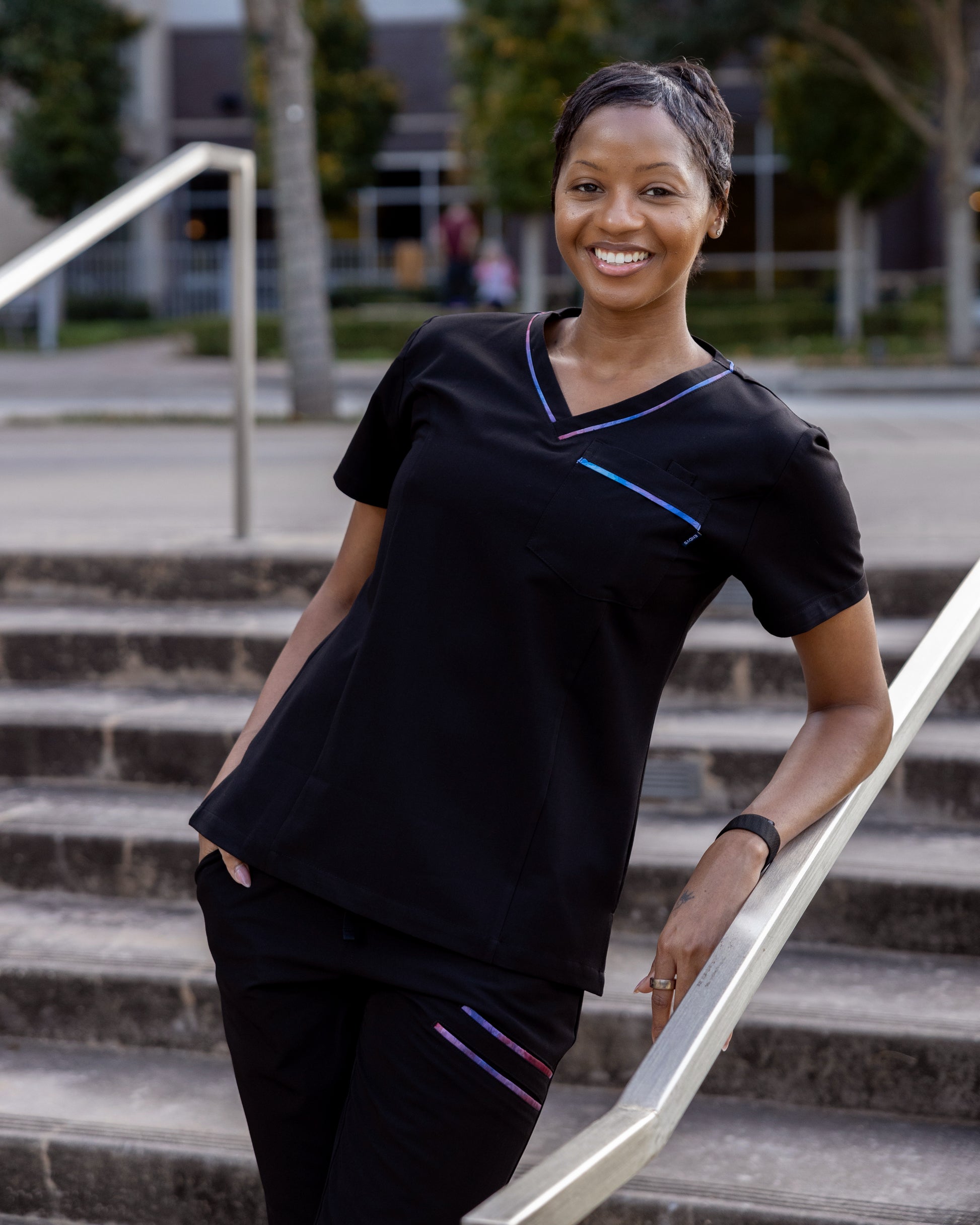 ENDYS Aurora women's scrub top side view — moisture-wicking, tagless, relaxed fit for long shifts